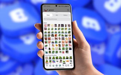 hand holding phone with a preview of the Emoji panel inside Discord app