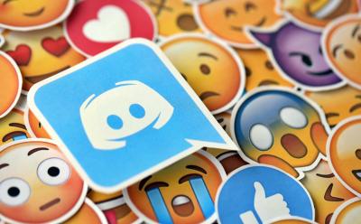 illustration featuring a Discord logo on top of a large set of stickers with Emojis