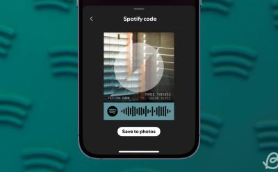 phone previewing the Spotify code for a song in front of a blurred background containing scattered Spotify logos