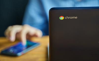 personal interacting with a Chromebook on a desk