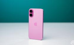 shot of the rear side of the iPhone 16 in pink colorway against a turqoise backdrop