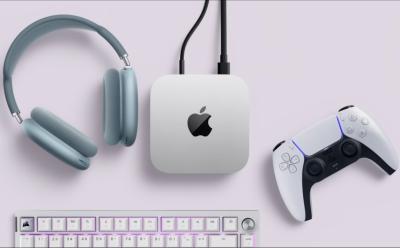 M4 Mac Mini placed along with AirPods Max, PS Controller, and a white gaming keyboard