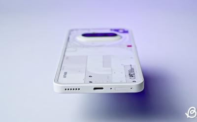 Nothing Phone (3a) in white laying flat showing the bottom USB Type C port