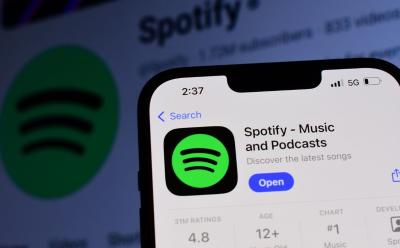 close-up shot of a phone showing the Spotify Premium app icon on Apple App Store